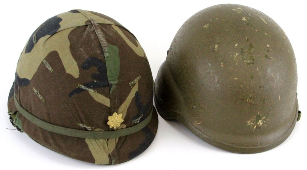 TWO US MILITARY ISSUE HELMETS KEVLAR AND M1: TWO US MILITARY ISSUE HELMETS KEVLAR AND M1 Two United States Military issue helmets: A modern Kevlar with full internal webbing and an M1 helmet and liner with camouflage cover and a Major's gold lea
