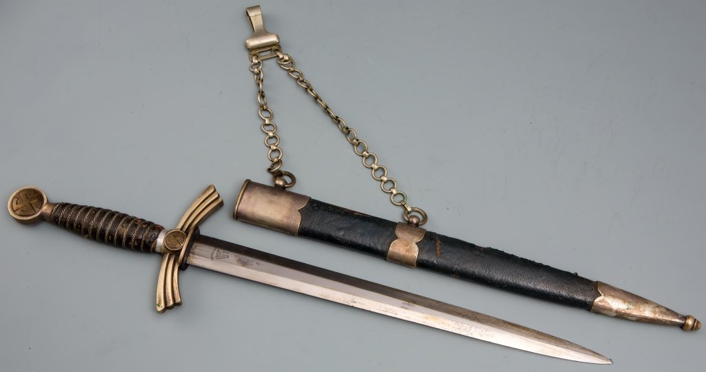 WWII GERMAN 1st MODEL LUFTWAFFE OFFICER’S DAGGER: WWII GERMAN 1st MODEL LUFTWAFFE OFFICER’S DAGGER 12 inch blade with SMF trade mark inscribed. 13.5 inch leather wrapped scabbard with 9 inch chain hanger. Very good condition with wire wrapped leath
