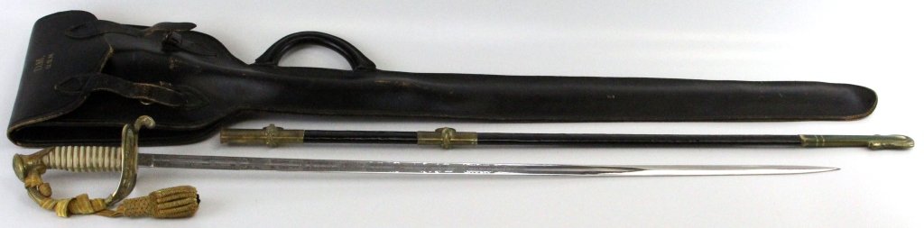 NAMED USN OFFICER’S DRESS SWORD WITH BAG & KNOT: NAMED USN OFFICER’S DRESS SWORD WITH BAG & KNOT Model 1902. 32 inch etched fullered blade by N.S. Meyer with name Donald Martin etched. 32.75 inch scabbard with green patina to brass fittings. 16 in
