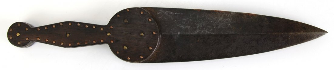 NORTHERN PLAINS INDIAN DAG TRADE KNIFE: NORTHERN PLAINS INDIAN DAG TRADE KNIFE 19th Century Northern Plains Indian dag trade knife. Dark wood beaver tail style handle with brass rivets. Heavy iron spear point blade. Measures about 13 inches