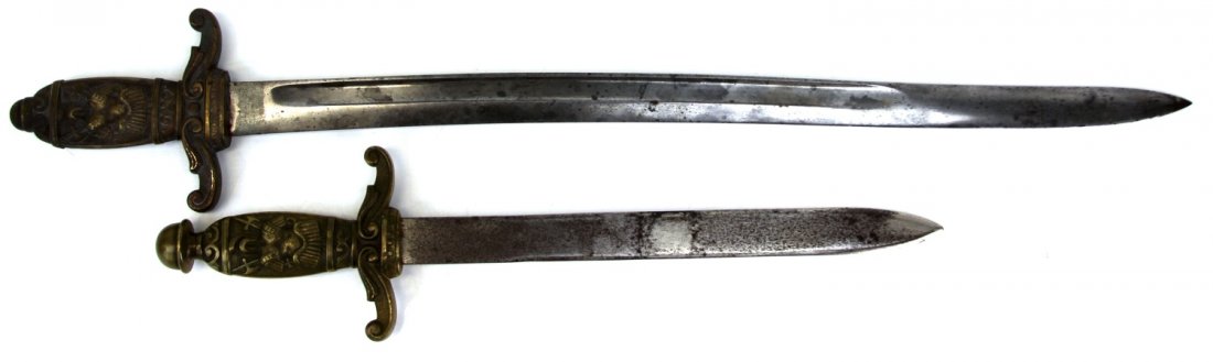 TWO MALITIA SWORDS WITH BRASS HILTS: TWO MALITIA SWORDS WITH BRASS HILTS Two unmarked ceremonial style edged weapons, with similar ornamental brass hilts. Both appear to be made with bayonet blades. blades measure 12.25 and 23 inches res