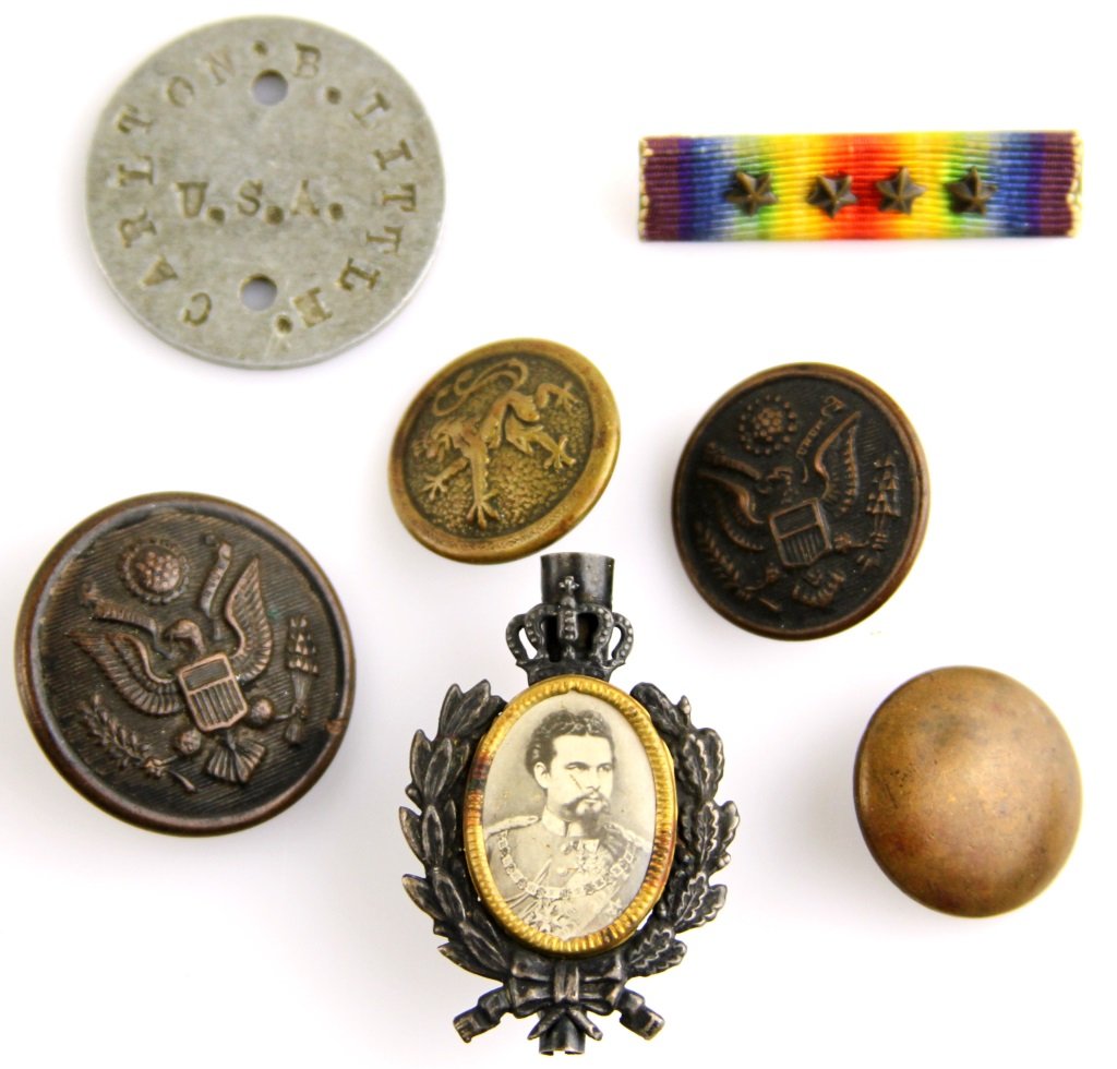 WWI FRANCIS FERDINAND PIN AND NAMED GROUPING: WWI FRANCIS FERDINAND PIN AND NAMED GROUPING Small WWI archive of Carlton B. Little including a 1.5" silver pin with a celluloid photo of Archduke Franz Ferdinand, dog tag, 4 buttons, and a bar. Era /