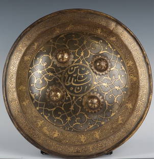 18th CENTURY INDO-PERSIAN GOLD DHAL SEPAR SHIELD: 18th CENTURY INDO-PERSIAN GOLD DHAL SEPAR SHIELD Highly detailed watered steel Dhal damascened in gold with Arabesques battle scenes and calligraphy. Original pad and liner. Circa 1780. Era / Conflict