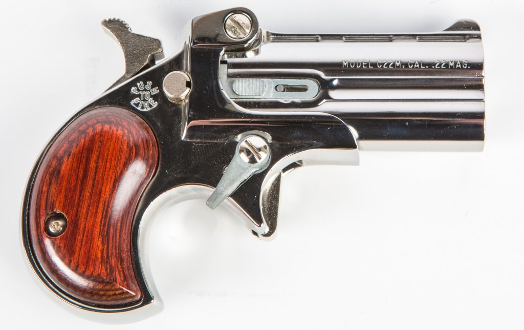 COBRA C22 OVER UNDER DERRINGER .22 MAGNUM: COBRA C22 OVER UNDER DERRINGER .22 MAGNUM Cobra C22 over under derringer in .22 magnum. Nickel plate with rosewood grips. Original box & literature. Caliber / Gauge: .22 mag Serial Number: 024417