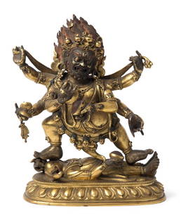 Mahakala Tibetochinesisch, 18./19.Jh. Feuervergoldete: Mahakala Tibetochinesisch, 18./19.Jh. Feuervergoldete Bronze, tlw. rot gefasst. Der sechsarmige, zornvolle Mahakala steht im Ausfallschritt nach rechts auf dem liegenden, elefantenköpfigen Gott Vinay