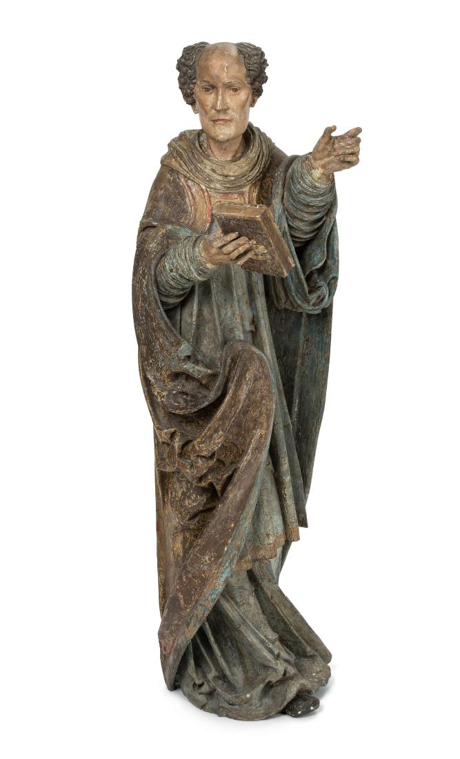 Heiliger mit Buch Österreich, um 1510/20. Holz: Heiliger mit Buch Österreich, um 1510/20. Holz geschnitzt und polychrom gefasst. Stehende Figur eines barhäuptigen Heiligen in Chormantel, Rochett und Untergewand, in der rechten Hand ein Buch halte