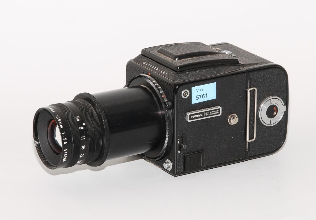 Fotoapparat "Hasselblad 2000 FC" Schweden, um 1980.: Fotoapparat "Hasselblad 2000 FC" Schweden, um 1980. Schwarzes tlw. beledertes Metallgehäuse. Mit Objektiv: EL-Nikkor 1:5,6 f135mm, Nr. 514285. L 22,5 cm.