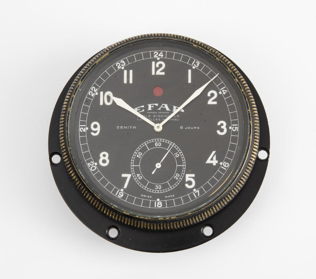 Zenith EFAP Borduhr Schweiz, 20.Jh. Eisengehäuse mit: Zenith EFAP Borduhr Schweiz, 20.Jh. Eisengehäuse mit verglaster Zifferfront welche gleichzeitig als Werksaufzug dient. Schwarzes Zifferblatt mit arabischen Ziffern und Signatur "Zenith EFAP Emile Eig