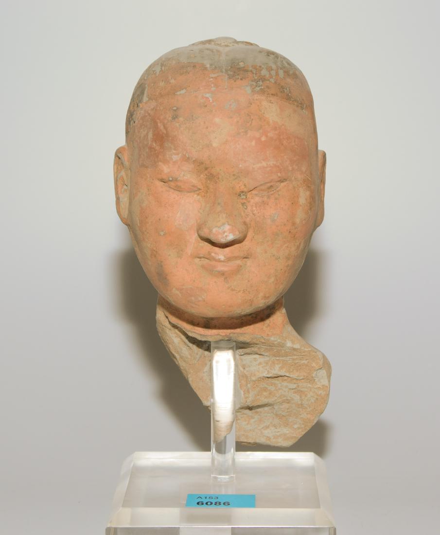 Männlicher Kopf: China, in der Art der Han-Dynastie. Ton, kalt bemalt. Kopffragment einer sogenannten "Stick Man"-Figur. H 15,5 cm. Auf Sockel montiert.