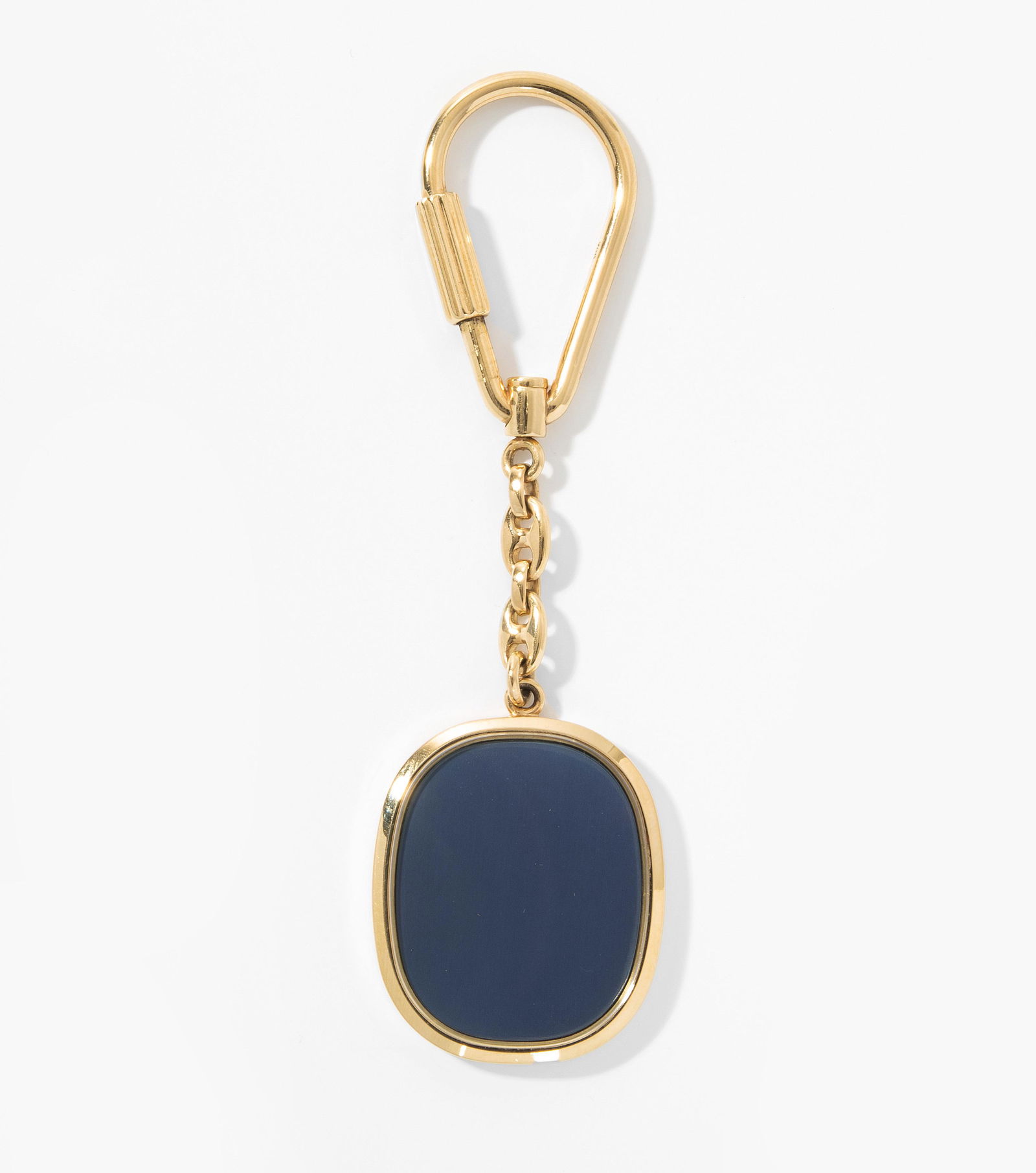 Patek Philippe Schlüsselanhänger: Modell Ellipse. 750 Gelbgold. Massiv mit Blaugold-Einlage unter Saphirglas. 26,2 g.