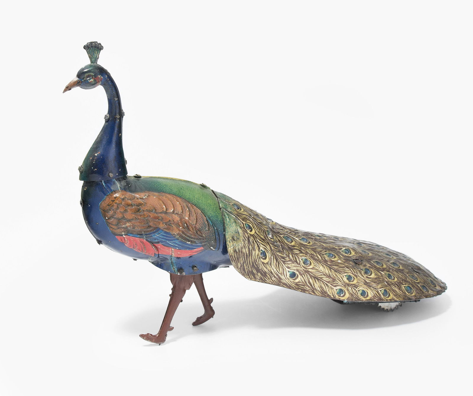 Hans Eberl-Pfau "PAO PAO": Deutschland, um 1915. Mit Firmensignet. Bezeichnet: "Ebo PAO PAO" und "Made in Germany D.R.G.M.". Blech, farbig lithographiert. Schreitender Pfau mit ausgebreiteten Schwanzfedern. Mit Blasebalg und Uh