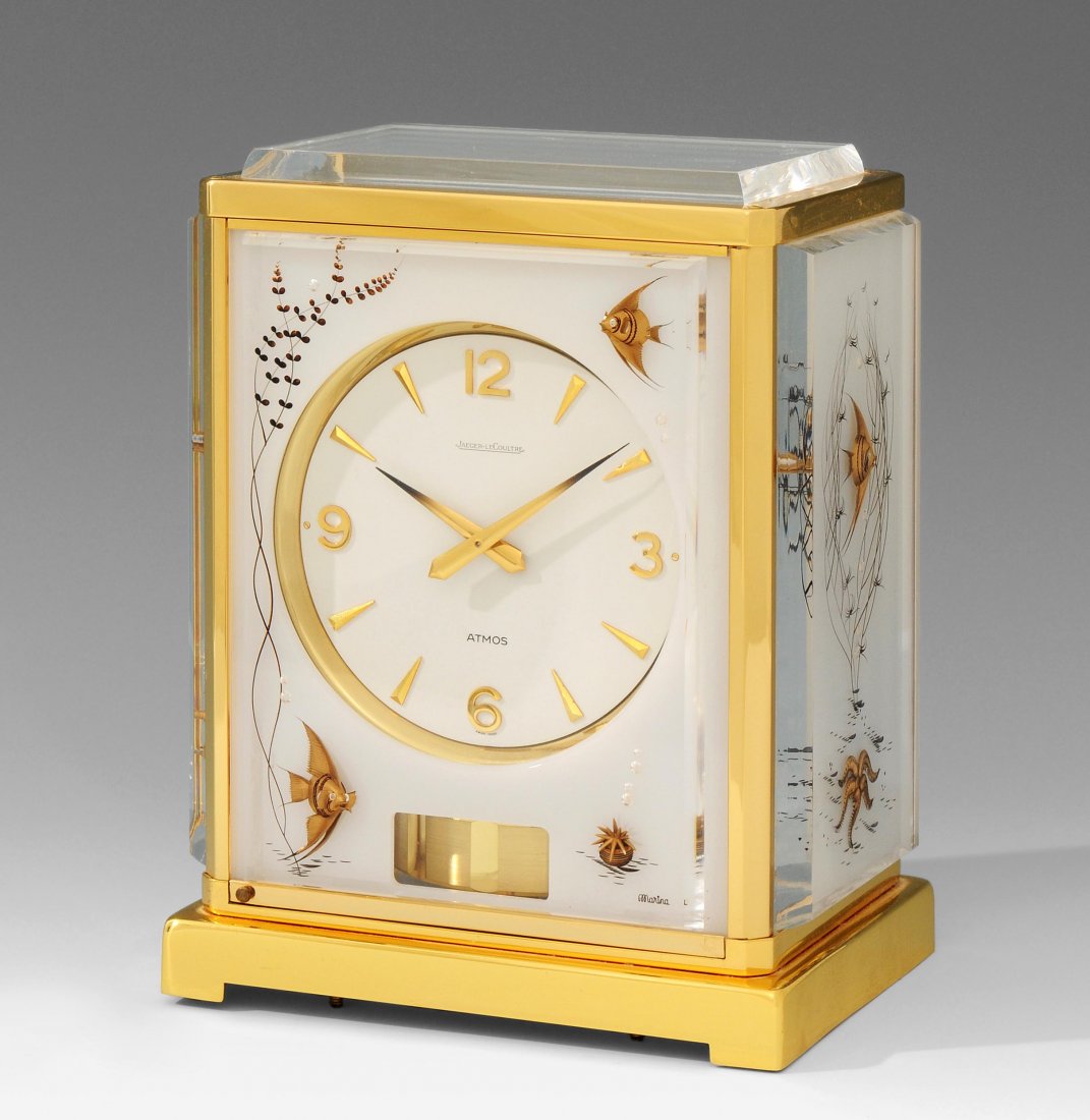 Atmos, Jaeger LeCoultre Modell Poisson Schweiz, ca.: Atmos, Jaeger LeCoultre Modell Poisson Schweiz, ca. 1980, Vergoldetes GehÃ¤use, 4Seitig mit milchglasfarbigem Plexiglas versehen und mit Aquarium Motiv hinterlegt. Weisser, in vergoldete LÃ¼nette 