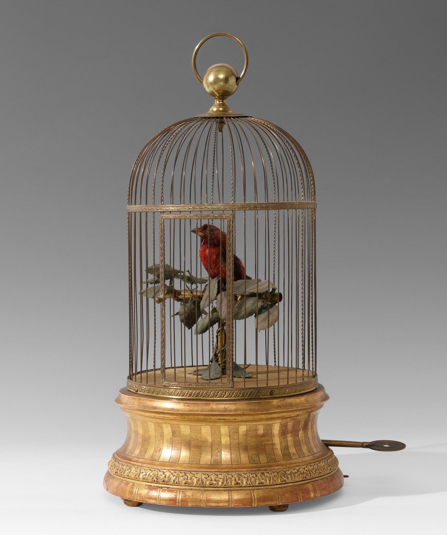 Singvogel-Automat Paris, Blaise Bontems, um 1870.: Singvogel-Automat Paris, Blaise Bontems, um 1870. Vogelkäfig aus Messing mit rot gefiedertem Singvogel. Im vergoldeten Holzsockel Mechanik und Musikwerk. H 57 cm / D 30 cm. - Museumsqualität.