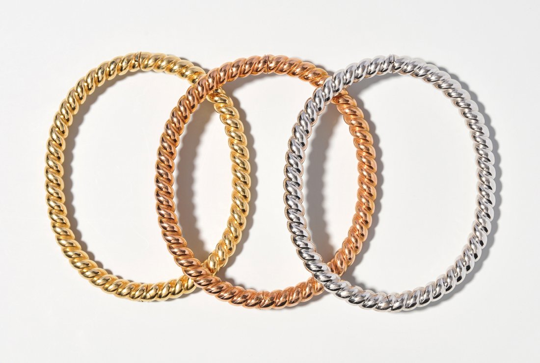 3 Gold-Armreife Bucherer. 750 Gelb-, Rot- und: 3 Gold-Armreife Bucherer. 750 Gelb-, Rot- und Weissgold. Gekordelt. Innenumfang 17,5 cm, 53,1 g.