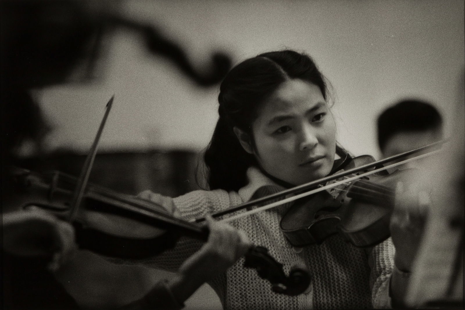 W. Eugene Smith (Am. 1918-1978), Violinist from the Hitachi Symphony, 1961, Gelatin silver print,: W. Eugene Smith (Am. 1918-1978) Violinist from the Hitachi Symphony, 1961 Gelatin silver print, matted Artist's estate stamp verso, Lowinsky Gallery label on mat verso 10 9/16" x 14 5/8" actu