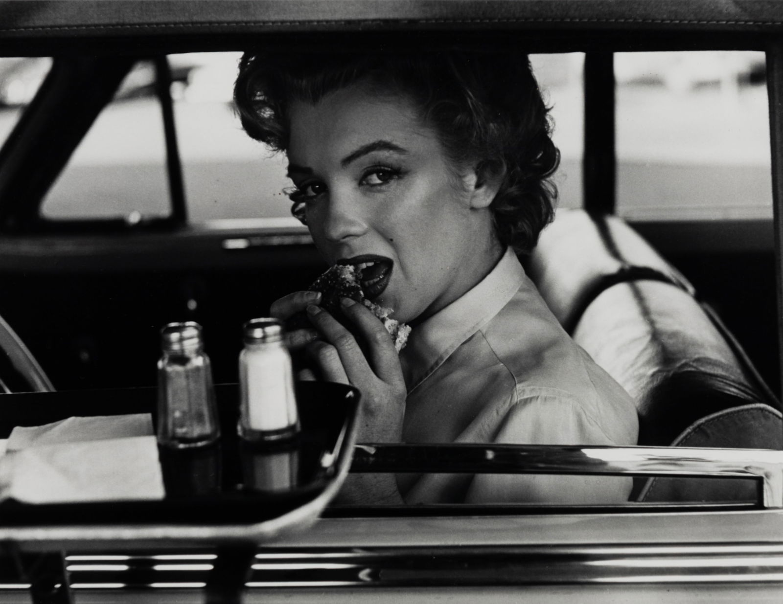 Philippe Halsman (Am. 1906-1979), Marilyn at the Drive-In, 1952, Gelatin silver print, framed under: Philippe Halsman (Am. 1906-1979) Marilyn at the Drive-In, 1952 Gelatin silver print, framed under glass Editioned "76/250" in artist's stamp on verso 9 3/4" x 12 1/2" actual, 16 5/8" x 20 9/1