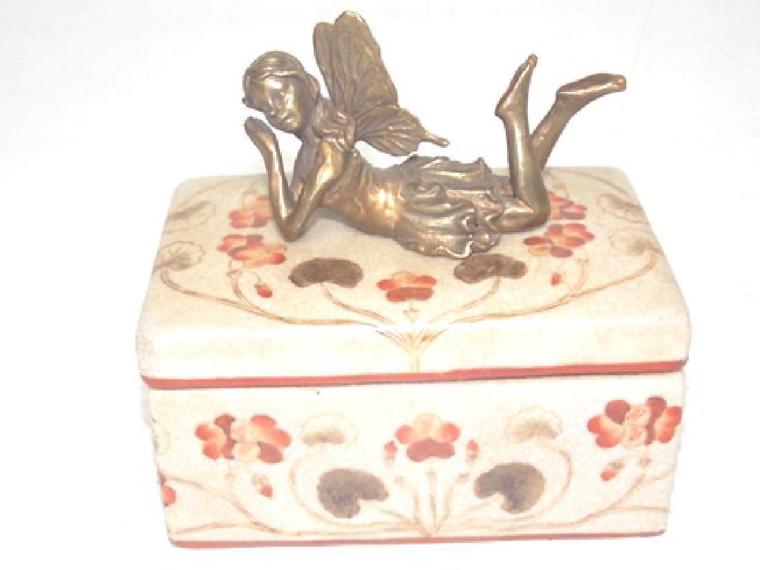 FLORAL PORCELAIN VANITY BOX W/ BRONZE FAIRY: A FLORAL PORCELAIN VANITY BOX WITH A BRONZE FAIRY. THE BOX MEASURES ABOUT 5 1/4" TALL BY 5 1/2" LONG BY 3 1/4" WIDE. SHIPPING AND HANDLING IS $20 WITHIN THE CONTINENTAL US. ALL OTHER STATES AND COUNTR