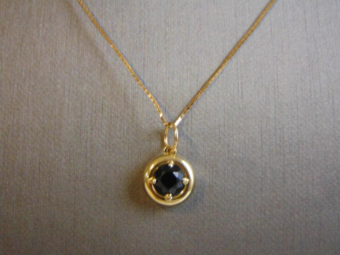 gold pendant with black stone