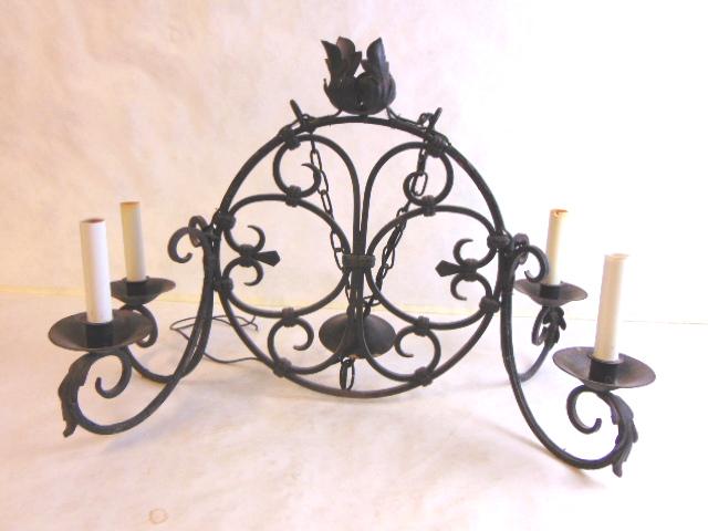 VINTAGE ANTIQUE WROUGHT IRON CHANDELIER LIGHT: A VINTAGE ANTIQUE WROUGHT IRON CHANDELIER LIGHT THAT MEASURES 22 1/2" LONG, BY 12 1/2" WIDE, AND HANGS ABOUT 22". CONDITION LOOKS GOOD FOR ITS AGE. LIGHT CAME FROM AN ESTATE IN PARIS,FRANCE. OWNER WAS