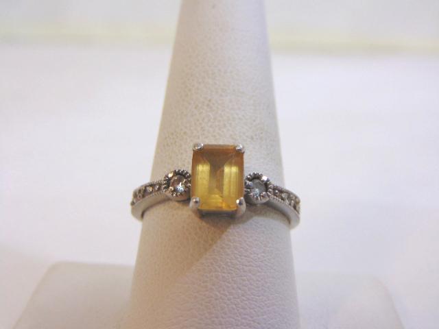 Womens Sterling Silver Ring w/ Diamond Cut Beryl Stone: FOR SALE IS THIS WONDERFUL WOMENS STERLING SILVER RING WITH A BERYL COLORED STONE WITH CZ CRYSTALS SURROUNDING IT. NOT SURE IF THE STONE IS REAL OR NOT. THE RING WEIGHS 2.7g. THE SIZE OF THE RING IS A