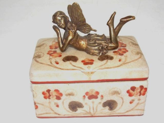 FLORAL PORCELAIN VANITY BOX W/ BRONZE FAIRY: A FLORAL PORCELAIN VANITY BOX WITH A BRONZE FAIRY. THE BOX MEASURES ABOUT 5 1/4" TALL BY 5 1/2" LONG BY 3 1/4" WIDE. SHIPPING AND HANDLING IS $20 WITHIN THE CONTINENTAL US. ALL OTHER STATES AND COUNTR