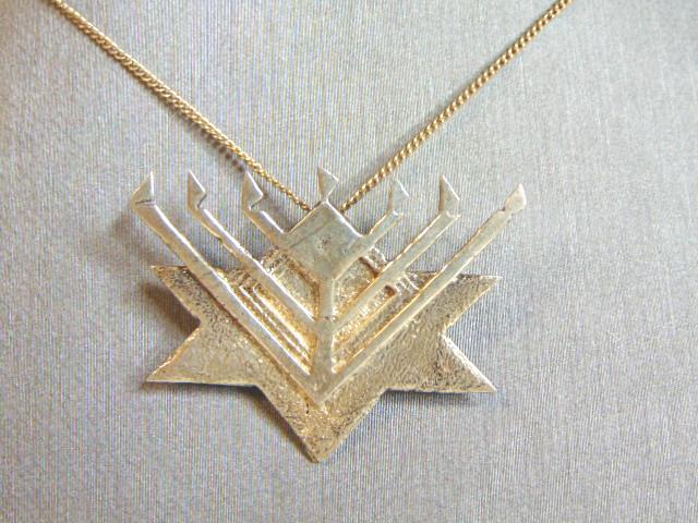 Vintage Sterling Silver Menorah Pendant w/ Necklace: A VINTAGE ESTATE STERLING SILVER MENORAH PENDANT WITH NECKLACE. THE NECKLACE MEASURE 20 5/8" AND THE PENDANT MEASURES 1 1/8" BY 1 1/2". TOGETHER THEY WEIGH 9.0g. ANY QUESTIONS PLEASE DO NOT HESITATE T