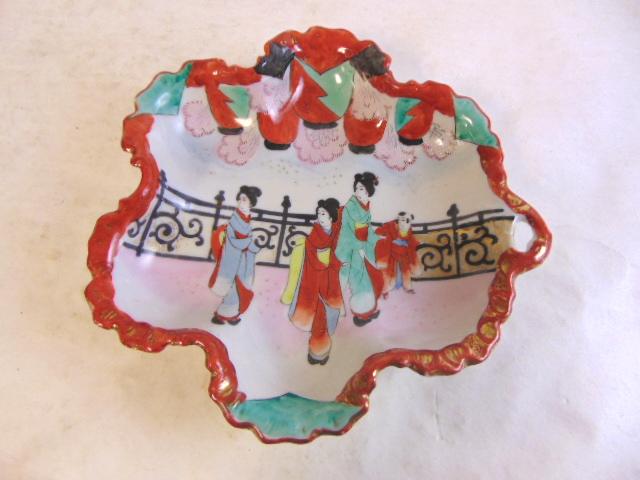 VINTAGE ANTIQUE HAND PAINTED NIPPON PORCELAIN BOWL: A VINTAGE ANTIQUE HAND PAINTED PORCELAIN BOWL THAT WAS MADE BY NIPPON OF JAPAN. PIECE MEASURES 2" TALL BY 10" LONG BY 10" WIDE. BOWL IS IN GREAT CONDITION. NO CHIPS OR CRACKS. SHIPPING AND HANDLING IS