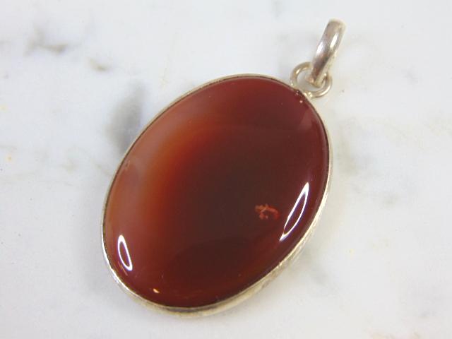 Womens Vintage Estate Sterling Silver Carnelian Pendant: FOR SALE IS THIS LOVELY VINTAGE STERLING SILVER CARNELIAN PENDANT. NOT SURE IF STONE IS REAL OR MAN MADE. THE TOTAL WEIGHT IS 13.2g. THE PENDANT MEASURES 2 1/8" WIDE BY 1 1/8 " LONG. MAKES A GREAT GIF