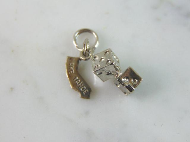 Womens Vintage Sterling Silver Lake Tahoe Dice Charm: FOR SALE IS THIS WOMENS VINTAGE ESTATE STERLING SILVER LAKE TAHOE DICE CHARM. CHARM WEIGHS 2.6g AND MEASURES 7/8" LONG BY 1/4" WIDE. MAKES A GREAT GIFT FOR THAT SOMEONE SPECIAL. IF ANY QUESTIONS, PLEA