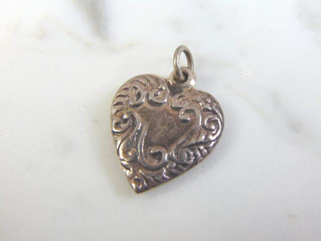 Womens Vintage Estate Sterling Silver Heart Charm: FOR SALE IS A VINTAGE ESTATE WOMEN'S STERLING SILVER HEART CHARM . CHARM MEASURES 7/8" LONG BY 5/8" WIDE AND WEIGHS 1.7g. MAKES A GREAT GIFT FOR THAT SOMEONE SPECIAL. IF ANY QUESTIONS, PLEASE ASK. BE 
