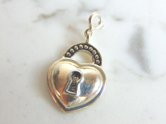 Womens Vintage Estate Sterling Silver Heart Lock Charm: FOR SALE IS A UNIQUE VINTAGE ESTATE WOMEN'S STERLING SILVER HEART LOCK CHARM . CHARM MEASURES 1 1/4" LONG BY 5/8" WIDE AND WEIGHS 5.8g. MAKES A GREAT GIFT FOR THAT SOMEONE SPECIAL. IF ANY QUESTIONS, P