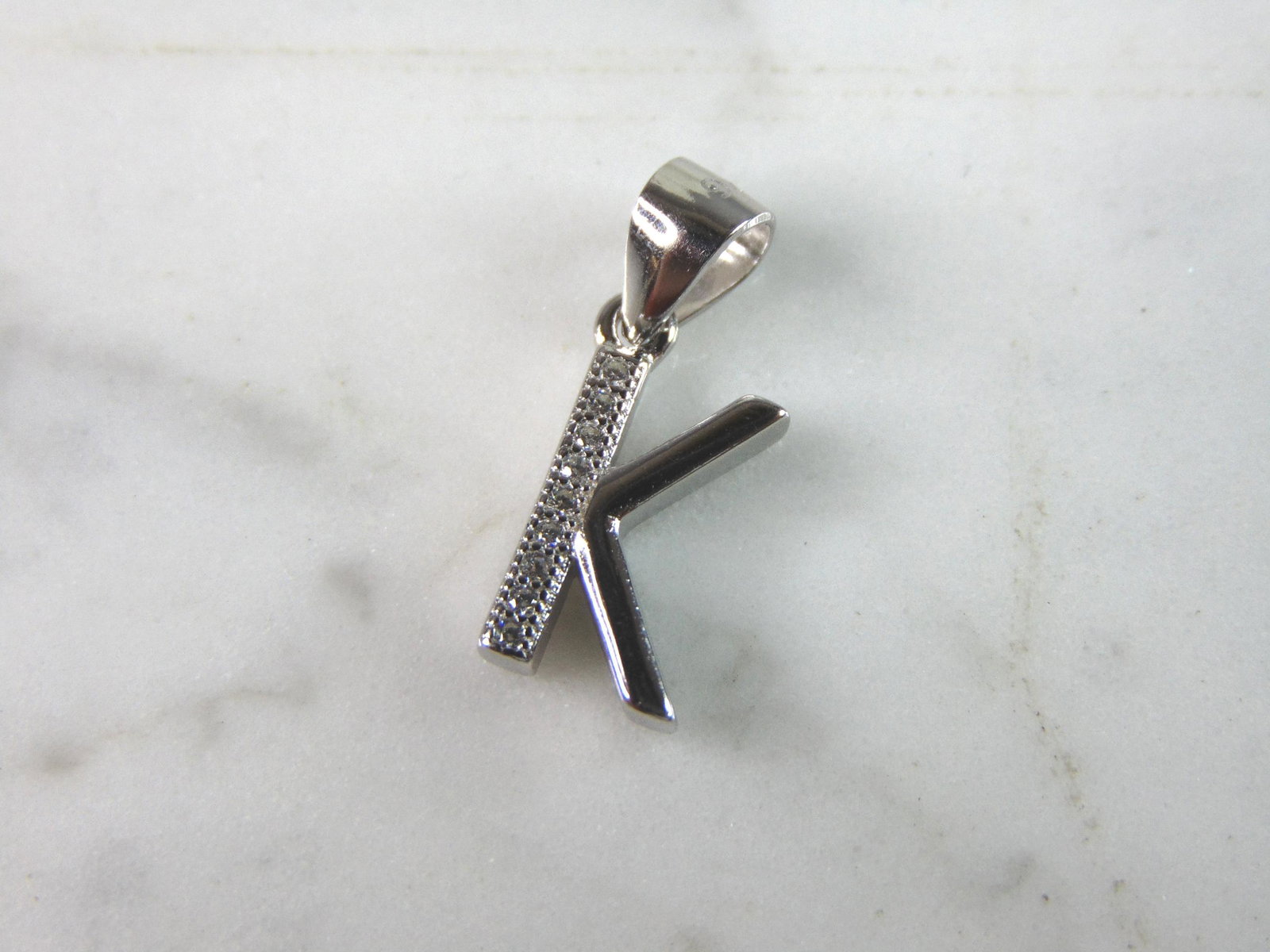 Womens Vintage Estate Sterling Silver CZ Letter "K" Pendant: FOR SALE IS THIS WOMENS VINTAGE ESTATE STERLING SILVER CZ LETTER "K" PENDANT. PENDANT WEIGHS 1.4g AND PENDANT MEASURES 3/4" LONG BY 3/8" WIDE. MAKES A GREAT GIFT FOR THAT SOMEONE SPECIAL. IF ANY QUEST