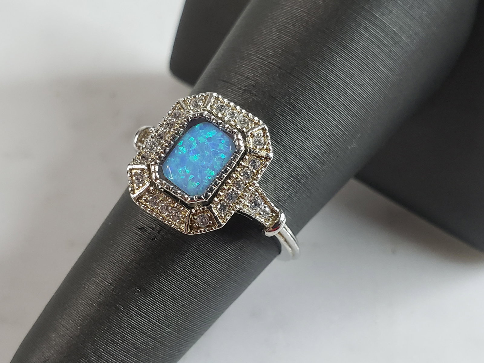 Womens Estate Sterling Silver Modernist Blue Opal Ring: A WOMENS ESTATE STERLING SILVER MODERNIST OPAL COLORED RING. THE RING IS A SIZE 6.25 AND WEIGHS 3.0g. WIDTH OF THE RING MEASURES 1/2". NOT SURE IF STONE IS NATURAL OR MAN MADE. THE RING MAKES A BEAUTI