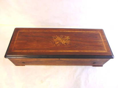 Antique Rosewood ? Marquetry Swiss Music Box: AN ANTIQUE SWISS MUSIC BOX THAT APPEARS TO HAVE A BEAUTIFUL MIX OF ROSEWOOD, AND MARQUETRY INLAY. THE BOX MEASURES 27 1/2" LONG BY 10 1/2" WIDE, BY 7" TALL. BOX IS BELIEVED TO BE SWISS MADE BUT COULD