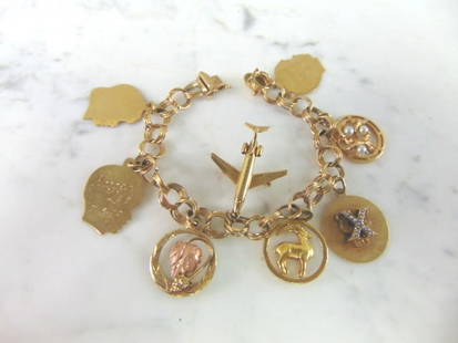 Womens Vintage Estate 14k Gold Charm Bracelet: A WOMENS VINTAGE ESTATE 14k GOLD CHARM BRACELET. THE BRACELET WEIGHS 33.8g, AND MEASURES 7" LONG. ALL ARE MARKED 14K EXCEPT FOR ONE OF THE CHILD TAGS AND THE ONE WITH ROSE GOLD. THE GRAPE LEAF ROSE GO