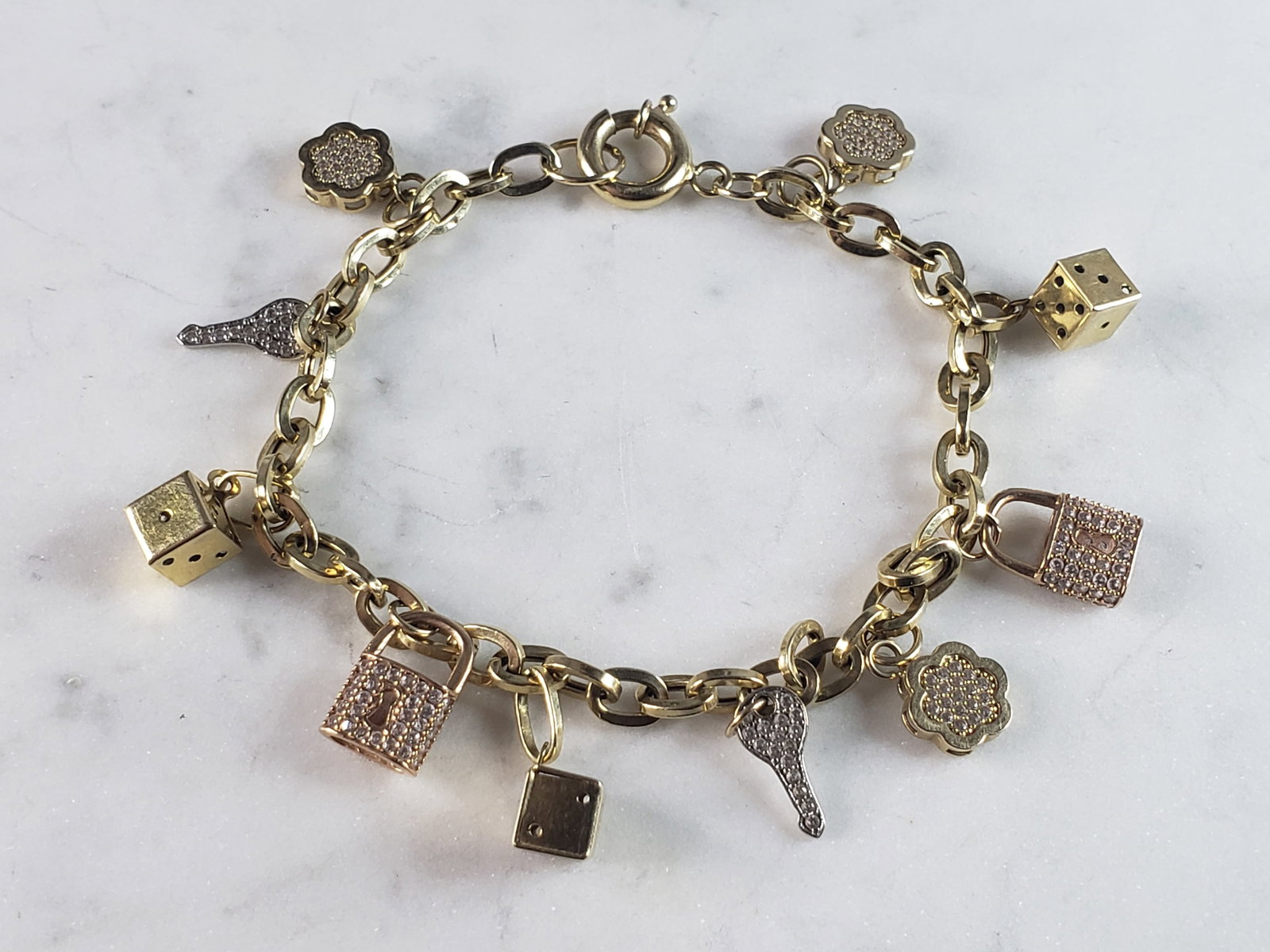Womens Vintage Estate 14k Gold Charm Bracelet: FOR SALE IS A WOMENS VINTAGE ESTATE 14k GOLD CHARM BRACELET. THE BRACELET WEIGHS 12.0g, AND MEASURES 8" LONG. THE BRACELET AND DICE ARE MARKED 14K. THE OTHER CHARMS ARE NOT MARKED. ANY QUESTIONS PLEAS