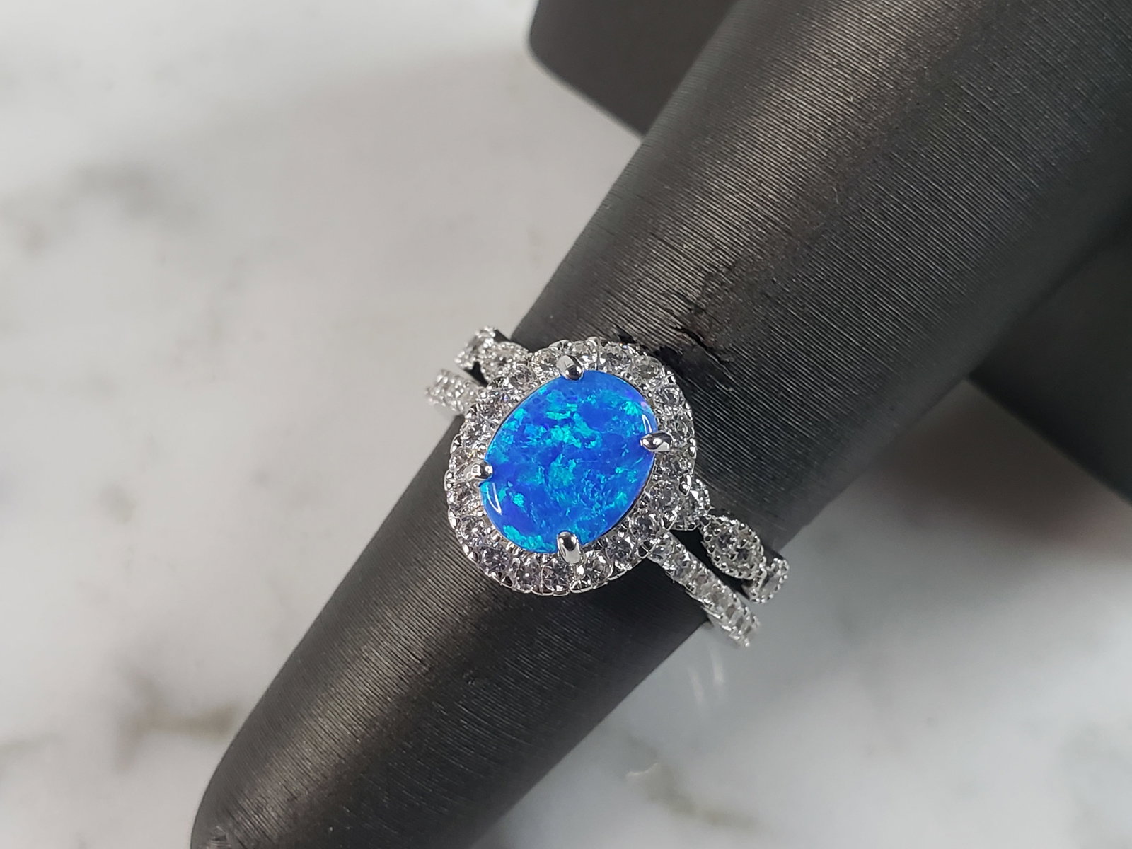 Womens Estate Sterling Silver Modernist Blue Opal & CZ Ring Set: A WOMENS ESTATE STERLING SILVER MODERNIST BLUE OPAL COLORED RING SET. THE RING IS A SIZE 6.0 AND WEIGHS 4.6g. WIDTH OF RING MEASURES 1/2". NOT SURE IF STONE IS NATURAL OR MAN MADE. THE RING MAKES A BE
