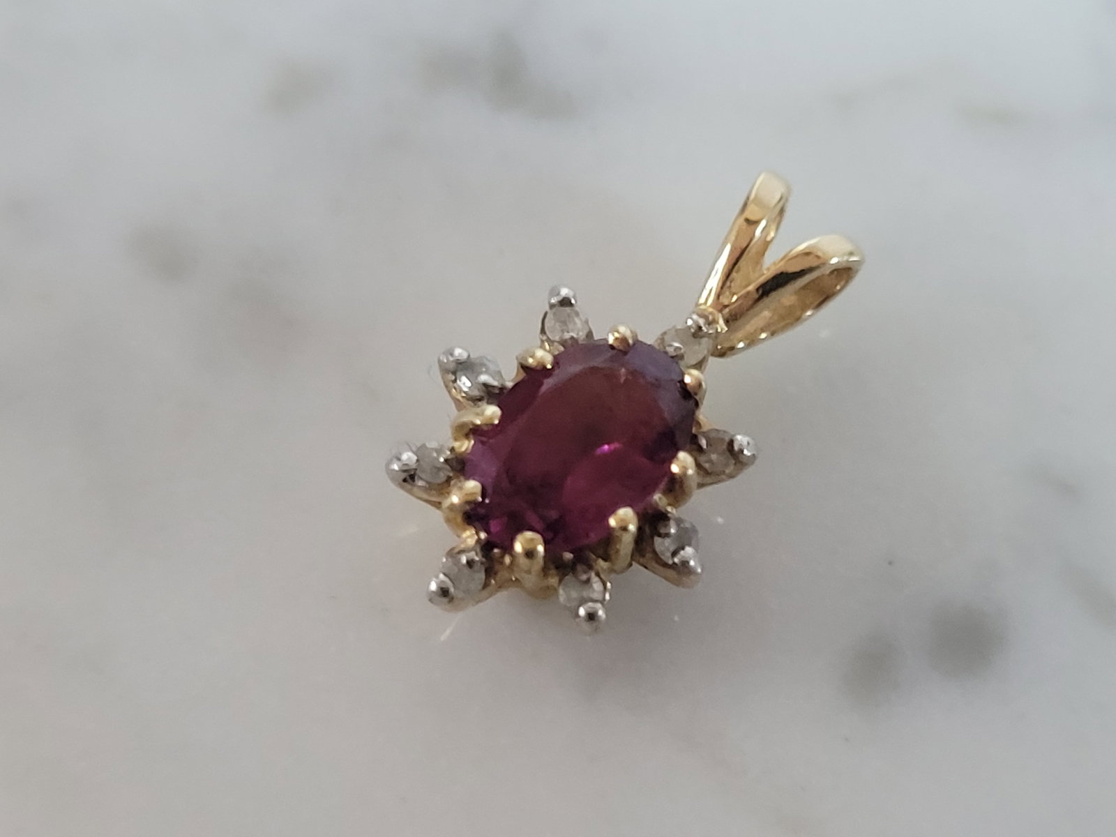 Womens Vintage Estate 14k Gold Garnet Diamond Pendant: A WOMENS VINTAGE 14K YELLOW GOLD GARNET & DIAMOND PENDANT . THE TOTAL WEIGHT IS 1.1g. THE PENDANT MEASURES 5/8" LONG BY 3/8" WIDE. THERE ARE ABOUT .07cts OF DIAMONDS. ANY QUESTIONS PLEASE DONT HESITAT