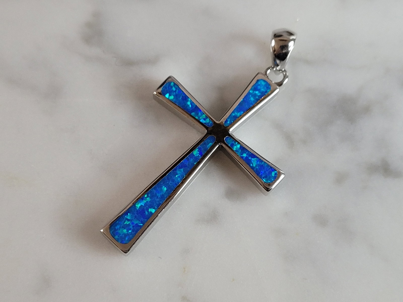 Womens Sterling Silver Blue Opal Religious Cross Pendant: A WOMENS ESTATE STERLING SILVER BLUE OPAL RELIGIOUS CROSS PENDANT. NOT SURE IF STONES ARE REAL OR MAN MADE. THE PENDANT WEIGHS 3.6g AND MEASURES 1 1/2" LONG BY 7/8" WIDE. MAKES A GREAT GIFT FOR THAT S