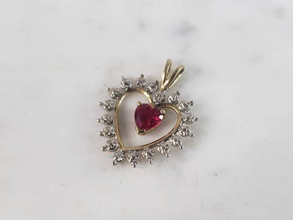 Womens Vintage Estate 10K Gold Heart Ruby Pendant: A WOMENS VINTAGE ESTATE 10K GOLD HEART PENDANT WITH A RUBY CENTER STONE. PENDANT WEIGHS 1.5g, AND MEASURES 7/8" BY 5/8". PENDANT IS MARKED ON THE BACK. WOULD MAKE A LOVELY GIFT FOR THAT SOMEONE SPECIA