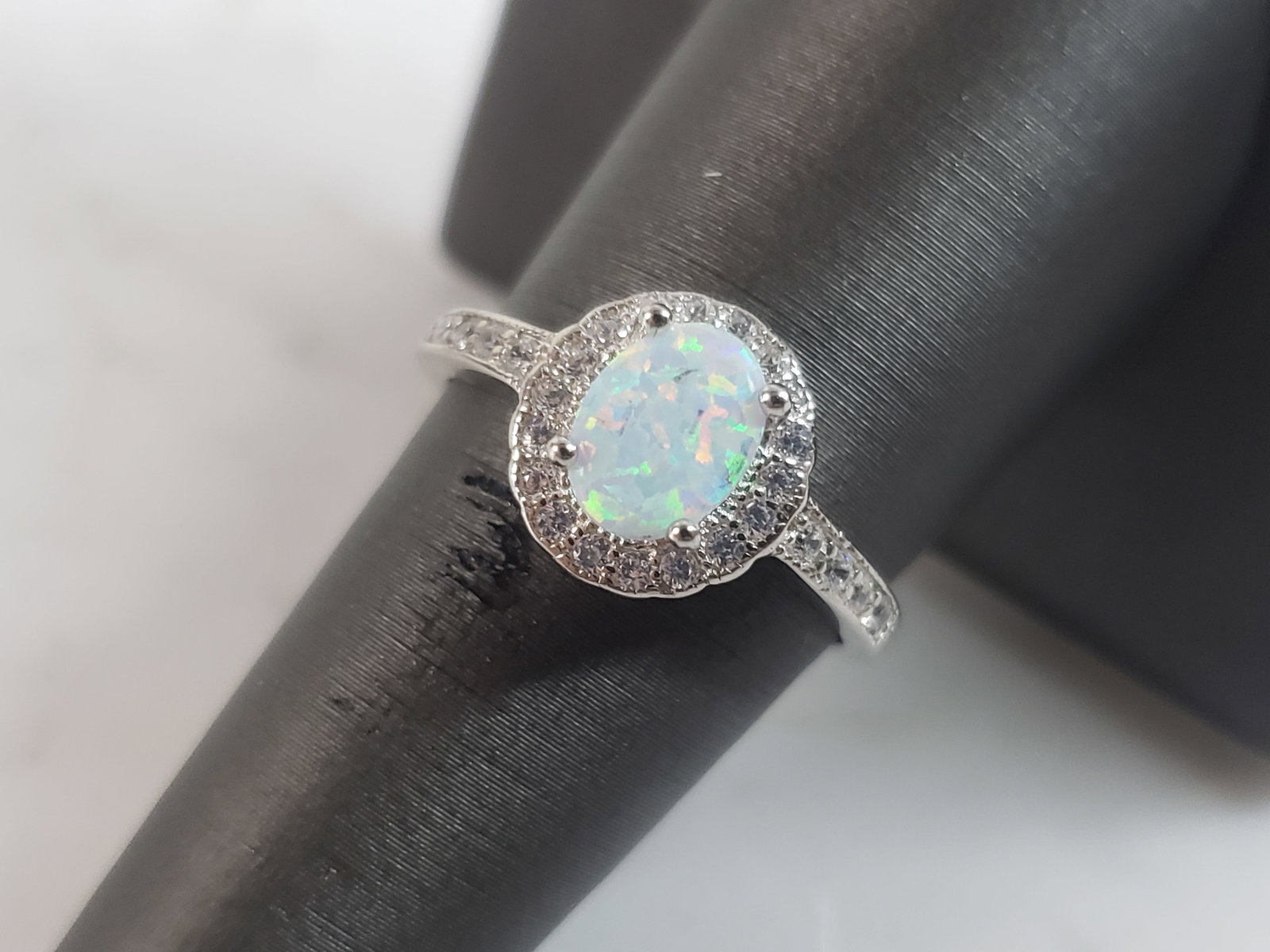 Womens Estate Sterling Silver Modernist Opal Ring: A WOMENS ESTATE STERLING SILVER OPAL STONE RING. NOT SURE IF STONES ARE REAL OR MAN MADE. THE RING WEIGHS 2.5g AND IS A SIZE 8.25. FACE MEASURES 3/8". MAKES A GREAT GIFT FOR THAT SOMEONE SPECIAL. IF A
