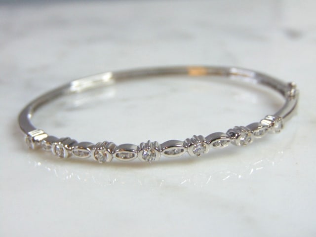 Womens Vintage Estate 18K White Gold Diamond Bracelet: A LOVELY VINTAGE ESTATE 18K WHITE GOLD BRACELET WITH DIAMONDS. THE BRACELET WEIGHS 9.8g. THE OPENING MEASURES ABOUT 2" BY 1 3/4". THERE ARE ABOUT .39cts OF DIAMONDS IN THE BRACELET. BRACELET HAS BEEN 