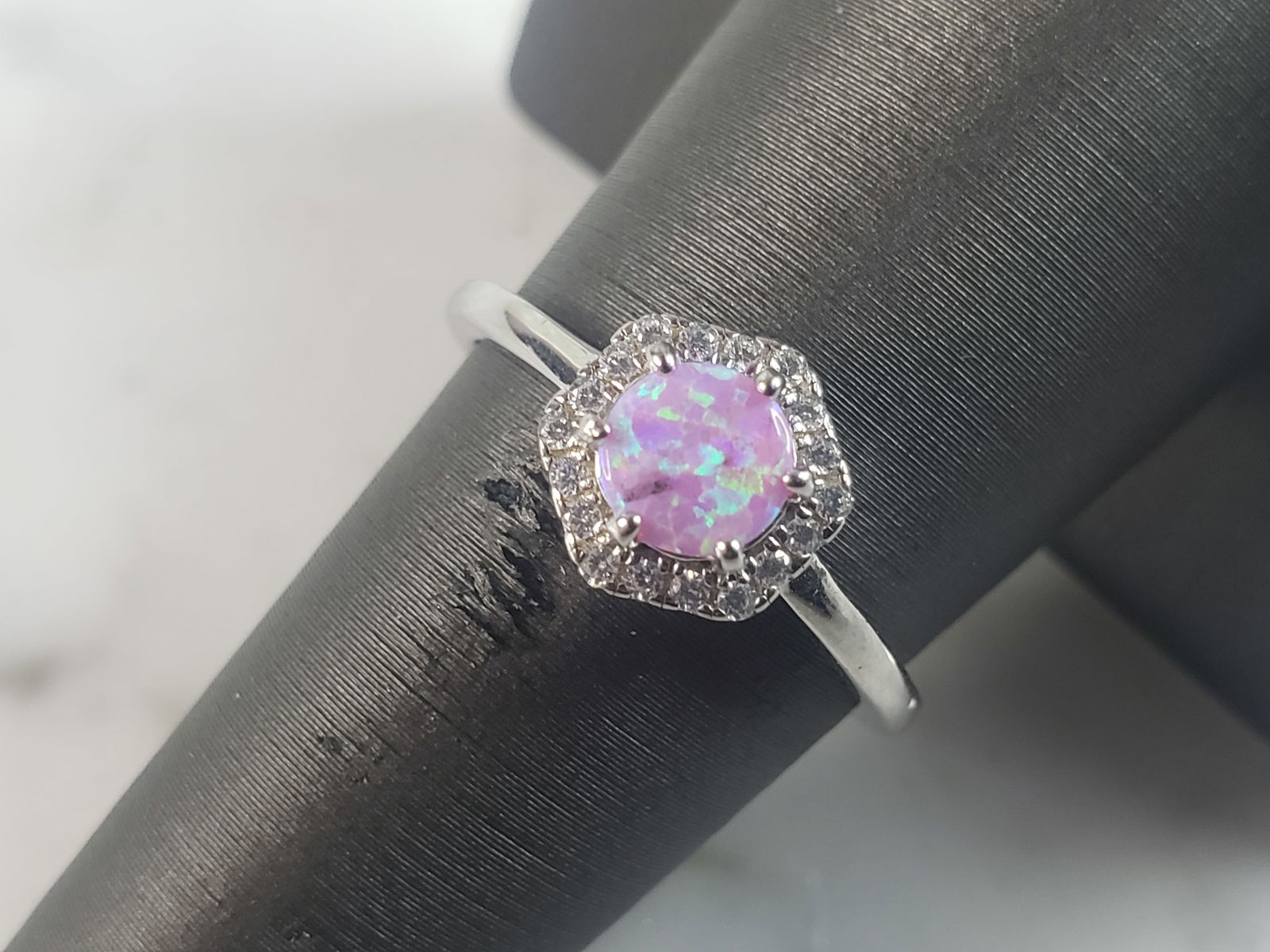 Womens Vintage Estate Sterling Silver Pink Opal Stone Ring: A WOMENS ESTATE STERLING SILVER PINK OPAL STONE RING. NOT SURE IF STONES ARE REAL OR MAN MADE. THE RING WEIGHS 2.5g AND IS A SIZE 6.75. FACE MEASURES 3/8". MAKES A GREAT GIFT FOR THAT SOMEONE SPECIAL.