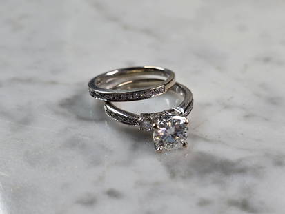 Womens Vintage Estate 18K White Gold Diamond Moissanite Ring Set: A WOMENS VINTAGE ESTATE 18K WHITE GOLD DIAMOND & MOISSANITE ENGAGEMENT RING SET. THE MAIN STONE IS MOISSANITE AND IS ABOUT 1.0ct. THE SIDE STONES ARE DIAMONDS THAT ARE ABOUT .05cts EACH, AND THE TINY