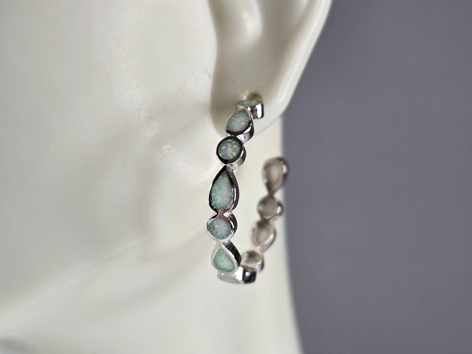 Womens Sterling Silver Modernist Opal Hoop Earrings: A PAIR OF WOMENS STERLING SILVER OPAL COLORED EARRINGS THAT WEIGH 3.9g, AND MEASURES 1" LONG BY 1/8" WIDE. NOT SURE IF STONES ARE NATURAL OR MAN MADE. ANY QUESTIONS, PLEASE DO NOT HESITATE TO ASK. BE