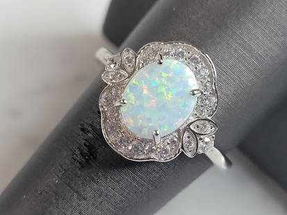 Womens Sterling Silver Modernist Opal Ring: A WOMENS STERLING SILVER MODERNIST OPAL RING. THE RING IS A SIZE 9.25, AND WEIGHS 4.3g. THE WIDTH OF THE RING IS 5/8". THE RING MAKES A BEAUTIFUL GIFT FOR THAT SOMEONE SPECIAL. ANY QUESTIONS, PLEASE A