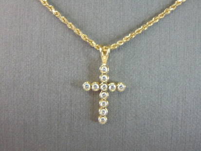 Womens Vintage 14K Gold Cross Pendant w/ Necklace: A VINTAGE ESTATE 14K GOLD NECKLACE WITH A CROSS PENDANT. TOGETHER THE CROSS AND NECKLACE WEIGHS 4.8g. THE PENDANT MEASURES 7/8" BY 1/2". THE ROPE NECKLACE MEASURES 18" LONG. STONES IN THE CROSS ARE CZ