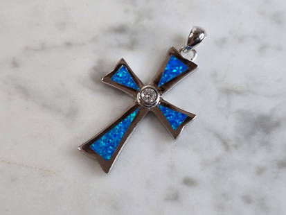 Womens Sterling Silver Blue Opal Religious Cross Pendant: A WOMENS ESTATE STERLING SILVER BLUE OPAL RELIGIOUS CROSS PENDANT. NOT SURE IF STONES ARE REAL OR MAN MADE. THE PENDANT WEIGHS 4.2g, AND MEASURES 1 3/8" LONG BY 3/4" WIDE. MAKES A GREAT GIFT FOR THAT