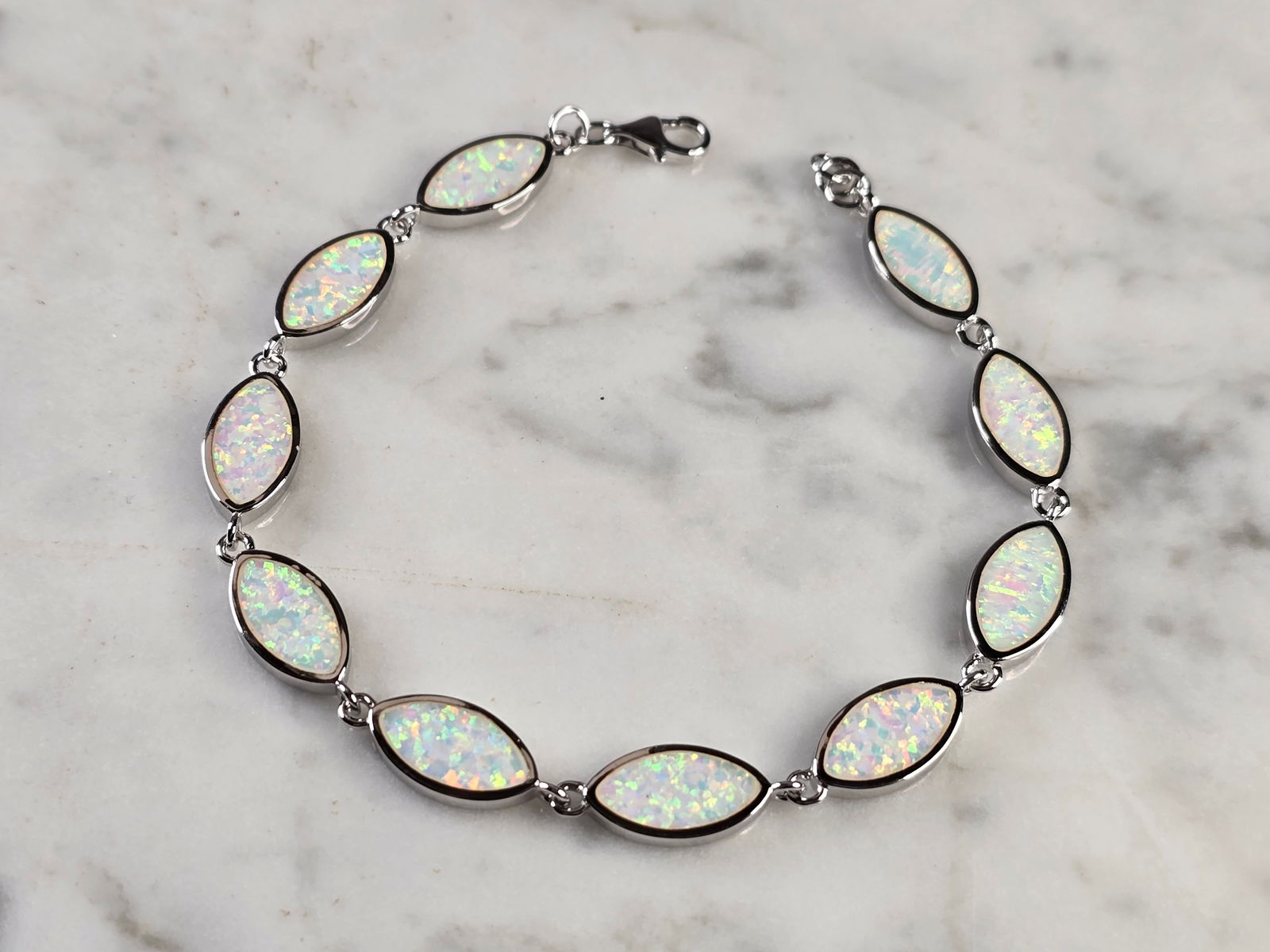 Womens Estate Sterling Silver Opal Modernist Bracelet: A WOMENS ESTATE STERLING SILVER MODERNIST OPAL COLORED BRACELET. THE BRACELET WEIGHS 10.5g AND MEASURES 7 1/2" LONG BY 1/4" WIDE. NOT SURE IF OPAL IS NATURAL OR MAN MADE. ANY QUESTIONS PLEASE DO NOT H