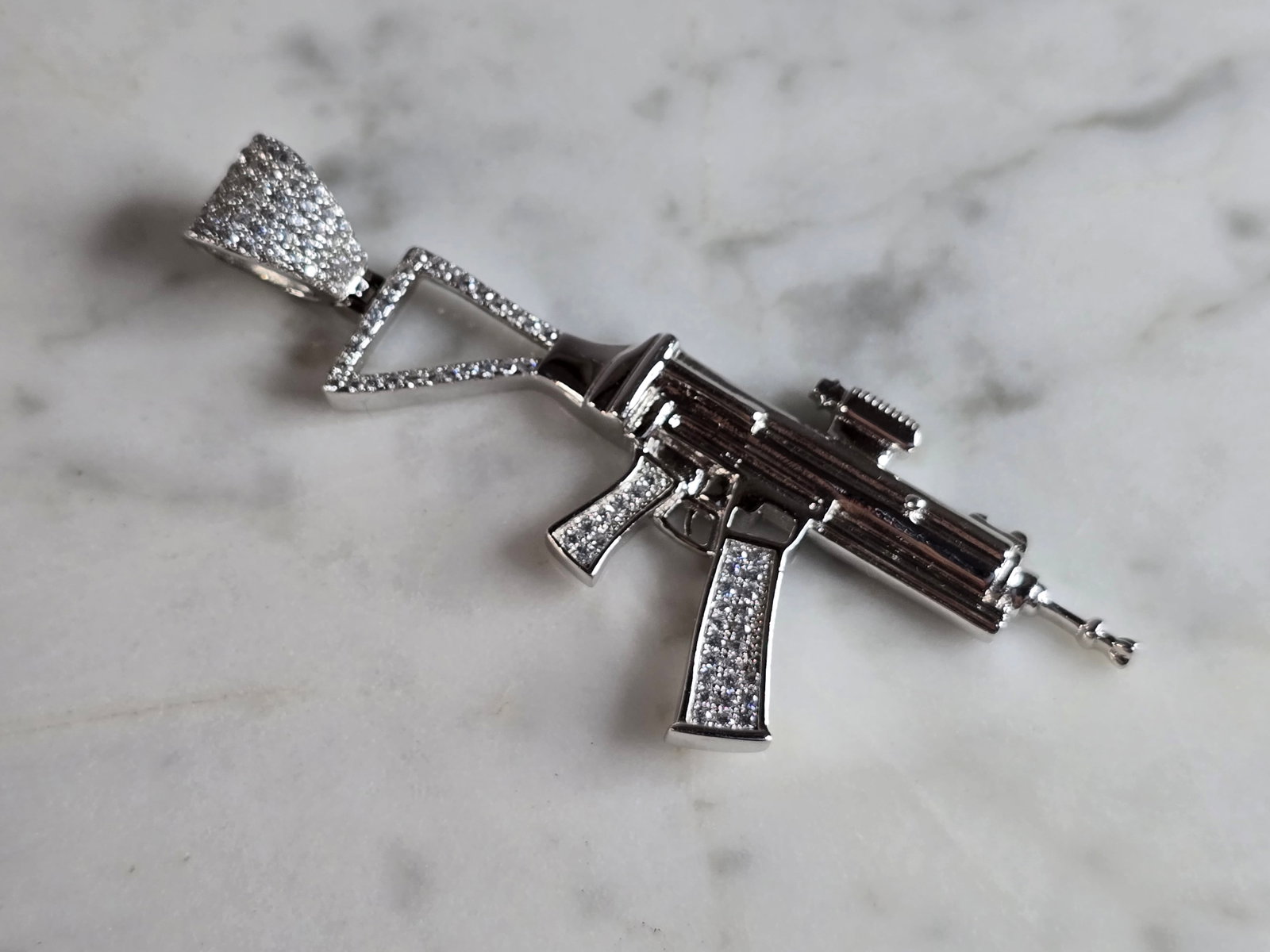 Vintage Estate Sterling Silver AK-47 Rifle Pendant: A VINTAGE ESTATE STERLING SILVER AK-47 RIFLE PENDANT THAT WEIGHS 8.9g. THE PENDANT MEASURES 2 1/2" BY 1". MARKED 925 ON THE BALE. MAKES A GREAT GIFT FOR THAT SPECIAL SOMEONE. ANY QUESTIONS, PLEASE DO 